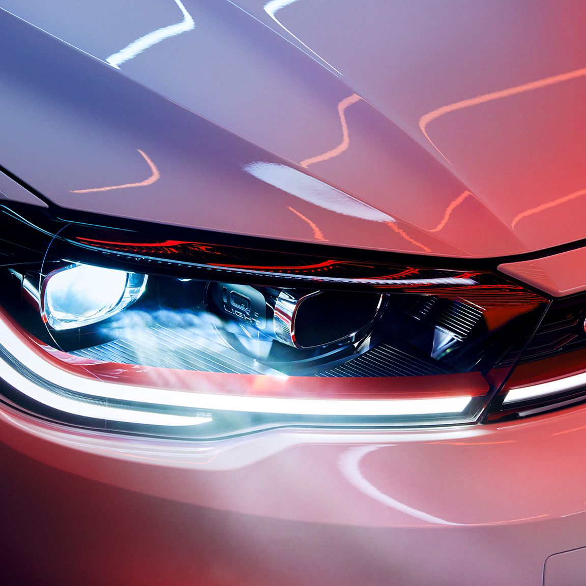 Detajlni posnetek matričnega LED-žarometa na sprednjem delu belega VW Pola GTI, vidna sta tudi rdeča okrasna linija in napis GTI.